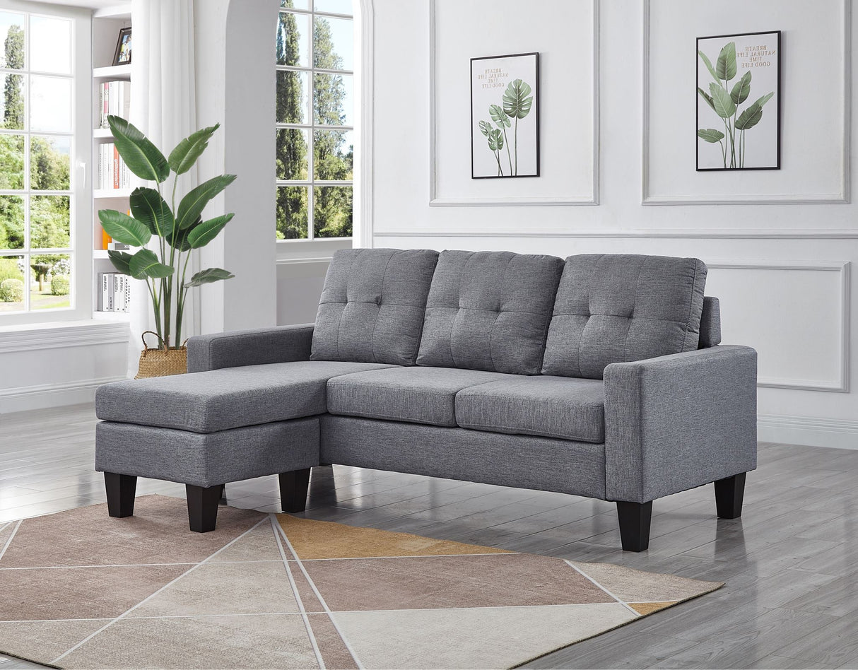 A light grey koa sectional L-shaped sofa with tufted buttons, featuring a chaise on the left side, which can be moved to the right side if needed.